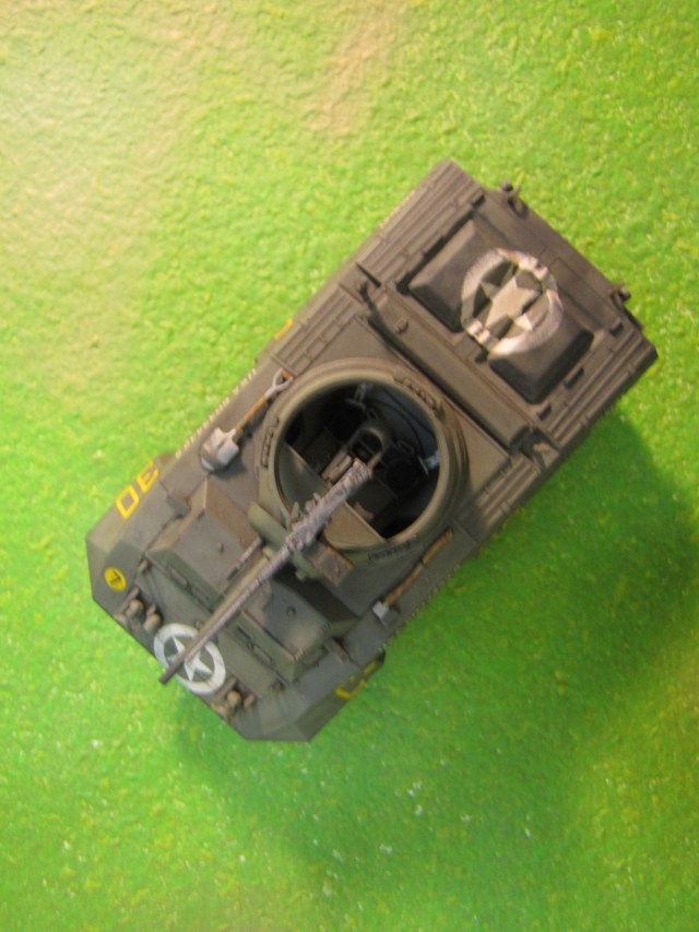 The open turret top is common on armored cars and other light units.  Its obviously a mixed blessing; it aids situational awareness and communication, but is a vulnerability, especially in urban settings.