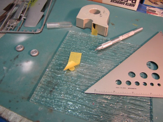 The wheel hubs are already painted, so the hubs are masked to paint the tires.