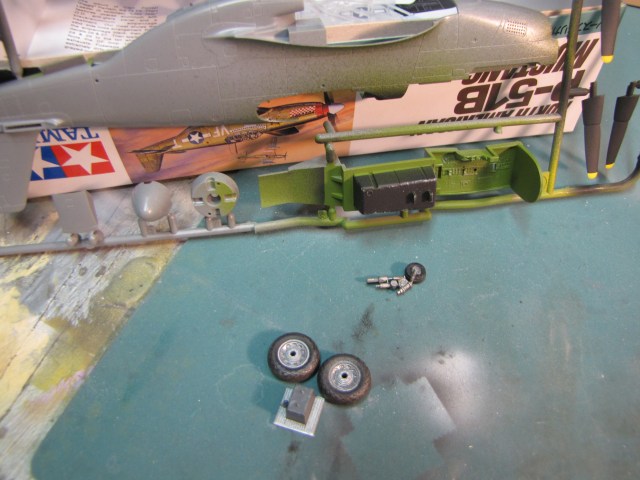 Now its time for some dry brushing.  An old brush with small amounts of medium grey paint is brushed across most of the painted surfaces.  The tires got the treatment with grey and brown to look like they've seen service at a poorly prepared airfield.